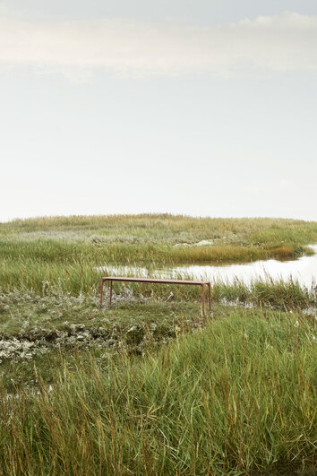 Novo Bänk i färgen Ginger Bread i öppet gräslandskap