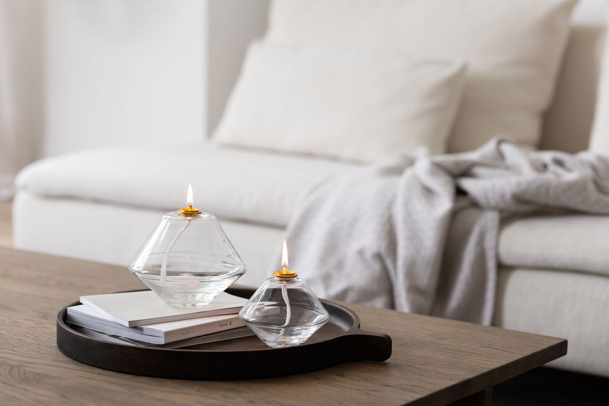 AKI Oljelampa Clear i storlekarna Stor och Liten på bricka med anteckningsblock