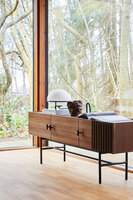 Array sideboard i valnöt ståendes framför stora panoramafönster