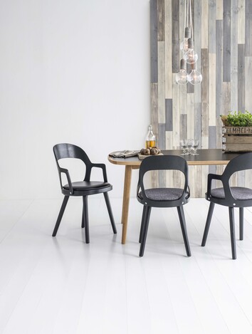 Colibri stol svartbetsad ek och med sits i bonded läder svart runt matbordet.